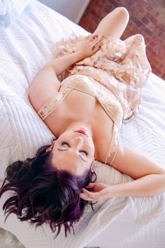 woman laying on bed during oklahoma boudoir session with kalee isenhour