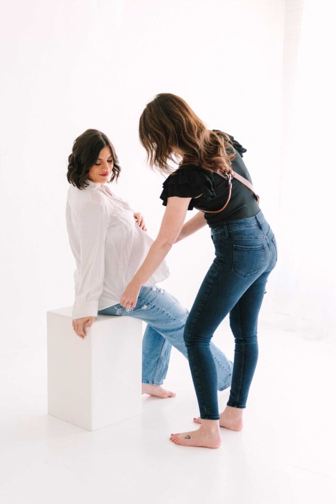 Photographer adjusting pose during portrait session