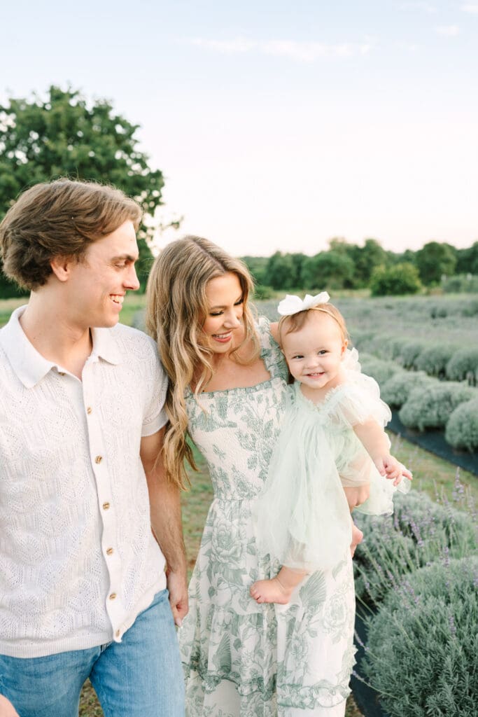 Family posing in a lavender field at Narrow Gate Farm near Oklahoma City during a summer photo session